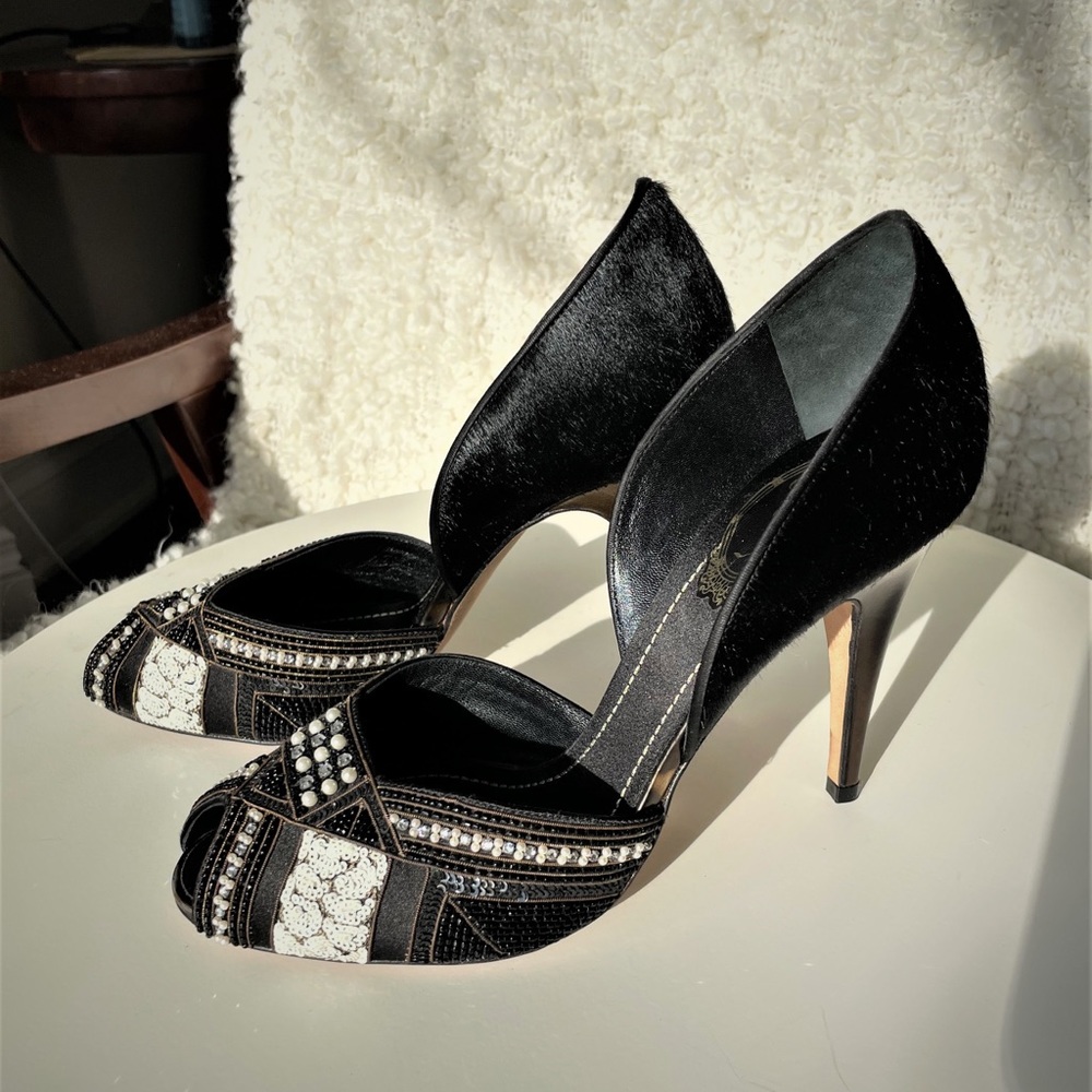 Stunning black calf hair and satin peep toe embellished pump.